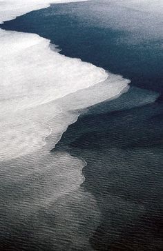 an aerial view of the ocean and land