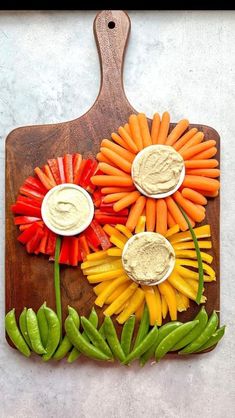 a cutting board with carrots, peppers and other vegetables on it