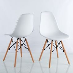 two white plastic chairs with wooden legs