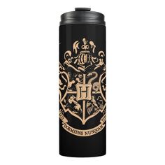 a black and gold harry potter hogwarts house logo on a black stainless steel water bottle