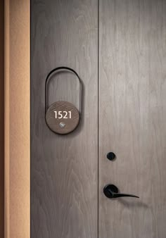 a wooden door with a lock on it and the number 1231 engraved on it