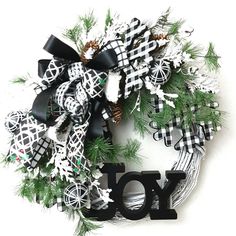 a black and white wreath with the word joy on it