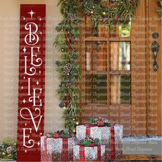 three wrapped presents sitting in front of a christmas sign with the word believe written on it