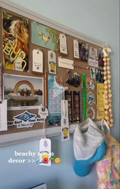 a bulletin board covered in pictures and magnets next to a wall hanging on the wall