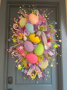 an easter wreath is hanging on the front door