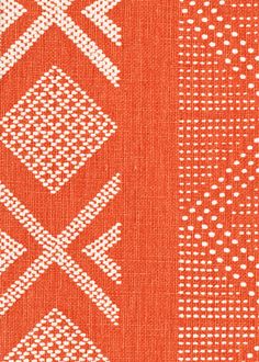 an orange and white fabric with different designs on it, including dots and lines in the middle