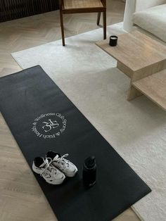 a pair of shoes sitting on top of a yoga mat