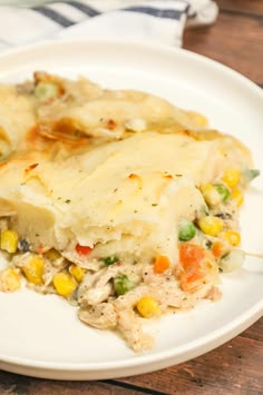 a white plate topped with mashed potatoes and veggie covered casserole