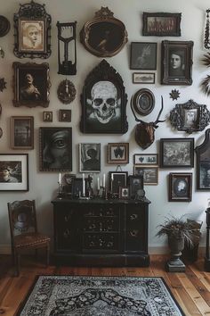 a room filled with lots of framed pictures on the wall next to a black dresser