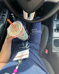 a person is holding a drink in their car