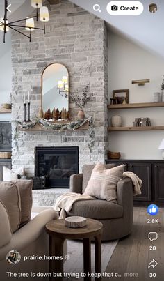 a living room filled with furniture and a fire place in front of a stone fireplace