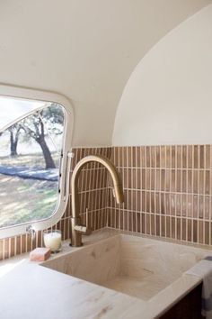 a kitchen sink and window in a small room