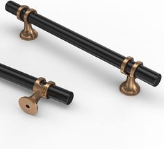 two black and gold door handles on a white background