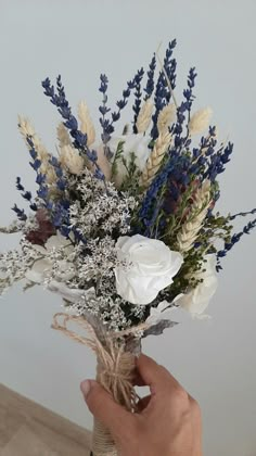 a person holding a bouquet of flowers in their hand