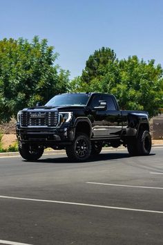 a black truck is parked on the street