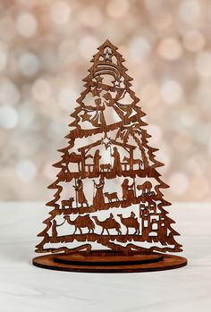 a wooden christmas tree on a white table