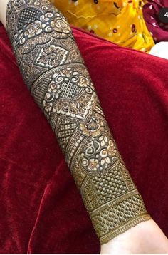 a woman's arm covered in henna