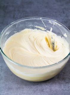 a glass bowl filled with batter on top of a table