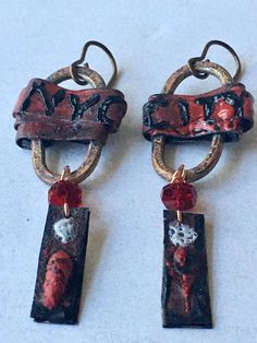 New York New York! Copper enamel dangle earrings featuring unique connectors created by Andrea from JosephineBeads, copper wrapped and with the handpainted letters NYC CITY, from which hang faceted ruby red Czech glass rondelles and abstract copper, handpainted strips. One of a kind. Earrings hang 5.5cm from vintaj ear wires. Artistic Red Enamel Jewelry, Artsy Red Nickel-free Earrings, Artsy Red Dangle Jewelry, Red Artsy Drop Earrings, Handmade Artsy Red Jewelry, Artisan Red Copper Earrings, Artsy Red Nickel-free Jewelry, Artsy Handmade Red Jewelry, Hand Painted Red Dangle Jewelry