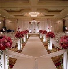 the aisle is lined with white and pink flowers