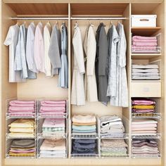 an organized closet with clothes and other items on shelves, including folded shirts in bins