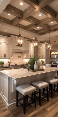 a kitchen with an island and four stools next to the center island in front of it