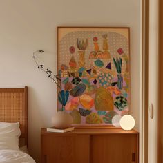 a painting is hanging on the wall above a bed