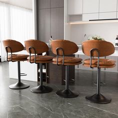 four brown chairs sitting in front of a counter