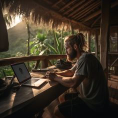 a man sitting at a table using a laptop computer