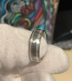 a close up of a person's hand with a wedding ring on top of it