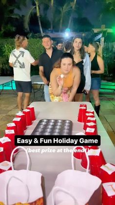 a group of people standing around a table with cups on it and an easy & fun holiday game