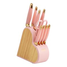 a pink and gold knife holder with six knives