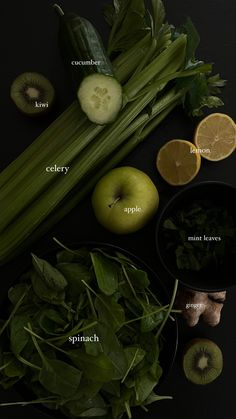 an assortment of fruits and vegetables on a black surface with the names in english, cucumber, celery, apple, spinach