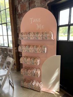 there is a pink display with boxes on it and the words take me written on it