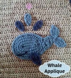 a blue crocheted animal laying on top of a rug