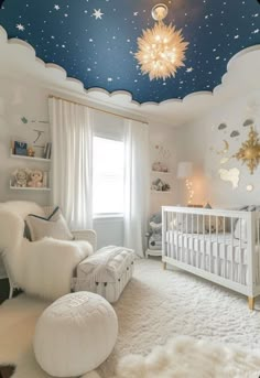 a baby's room decorated in white and blue with stars painted on the ceiling