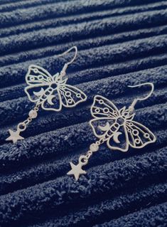 Beautiful mignight themed dangle earrings. Diamond rhinestone connector between silver coloured sweet moth charm and silver coloured star. Sterling silver hooks are the backings for these adorable earrings. Silver Moth Earrings, Christmas Deals, Cute Earrings, Moth, Silver Color, Jewelry Earrings Dangle, Dangle Drop Earrings, Dangle Earrings, Jewelry Earrings