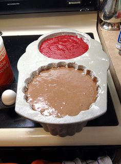 an uncooked pie pan sitting on top of a stove next to other baking supplies