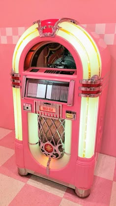 an old fashioned jukebox sitting on top of a checkered floor