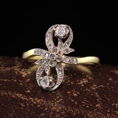 Beautiful Antique Edwardian 18K Yellow Gold Platinum Top Floral Diamond Ring. This gorgeous ring is crafted in 18k yellow gold and platinum top. The top of the ring is covered in rose cut diamonds and two larger old mine cut diamonds. The ring is in great condition and ready to wear. Item #R1543 Metal: 18K Yellow Gold and Platinum Weight: 3.4 Grams Size: 8 Diamonds: Approximately .40 cts Color: H Clarity: SI1 - SI2 Measurements: Top of the ring measures 17 mm wide and band measures 1.73 mm wide. Aquamarine Cocktail Ring, Antique Jewelry Rings, Heart Band, Gorgeous Ring, Top Floral, Gift Ring, Rose Cut Diamond, Watch Necklace, Gold Platinum