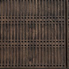 an old iron grate with holes in it