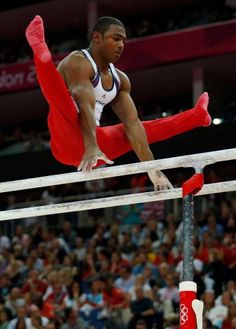 a man is doing an acrobatic trick on the bars