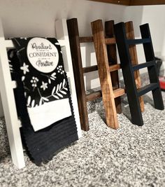 three wooden ladders sitting next to each other on top of a floor covered in carpet