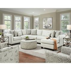 a living room filled with lots of white furniture