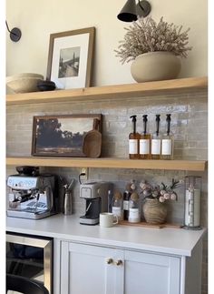 a kitchen counter with coffee maker and other items on it's shelf above the sink