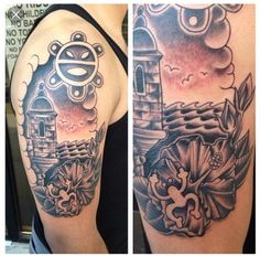 a woman's arm with a lighthouse and flowers tattoo design on the left shoulder