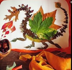 there is a plate with leaves and acorns on it next to other autumn decorations