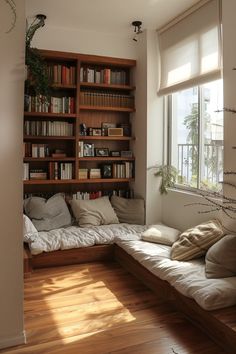 a living room filled with lots of furniture and bookshelves next to a window