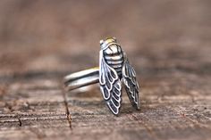 This listing is for one beautiful and detailed sterling silver cicada ring. This richly detailed cicada is fired onto a double half round wire band. Your ring will be made just for you in whatever size you choose. Wear this tree ring daily to remind yourself of your love of nature, transformation, renewal, rebirth, and change.  - Choose your size at check-out. - Cicada measures 20mm by 12mm. - Ring band is 4mm wide. Want to add silver stacking bands? Buy them here: https://www.etsy.com/listing/5 Cicada Ring, Nature Transformation, Bug Ring, Witch Ring, Insect Ring, Angel Ring, Witch Rings, Mushroom Ring, Mushroom Jewelry