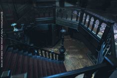 an old staircase with wooden handrails and red carpeted flooring in a dark room